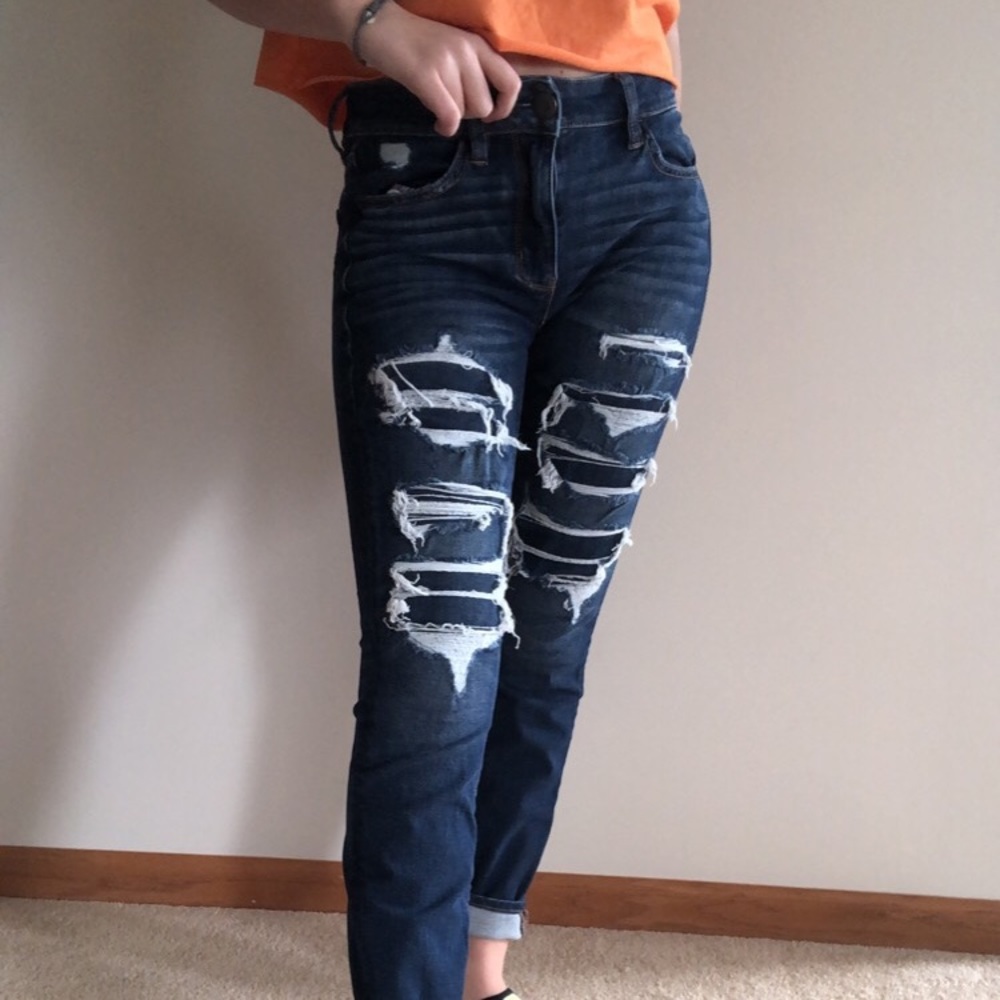 Dark wash holey covered skinny jeans